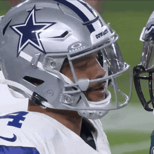A Football Player Wearing A Helmet That Says Cowboys On The Front GIF