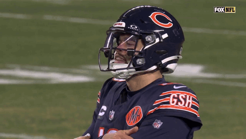 A Football Player Wearing A Helmet That Says Gsh GIF