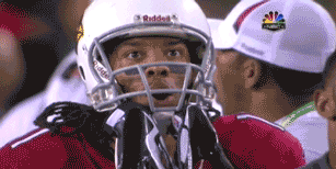 A Football Player Wearing A Helmet That Says Riddell GIF