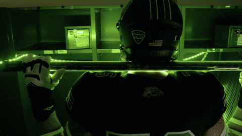 a football player wearing a helmet with bleed on it