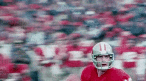 A Football Player Wearing A Helmet With The Number 11 On It Is Running On A Field GIF