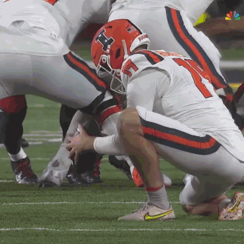 A Football Player Wearing A Helmet With The Number 11 On It GIF