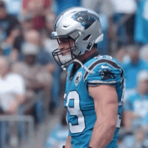 A Football Player Wearing A Helmet With The Number 9 On His Jersey GIF