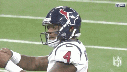 A Football Player Wearing A Helmet With The Number Four On It GIF