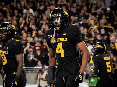 A Football Player Wearing A Jersey That Says Devils On It GIF