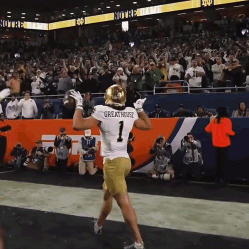 a football player wearing a jersey that says greathouse