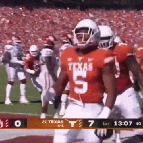 A Football Player Wearing A Jersey With The Number 5 On It Is Running On The Field . GIF