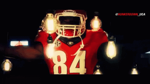 A Football Player Wearing A Jersey With The Number 84 On It GIF