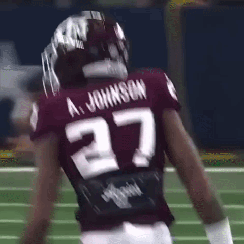 A Football Player Wearing A Maroon Jersey With The Number 27 On It . GIF