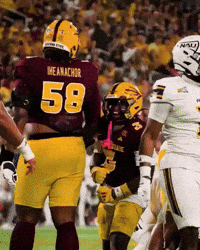 A Football Player Wearing A Maroon Jersey With The Number 58 On The Back GIF