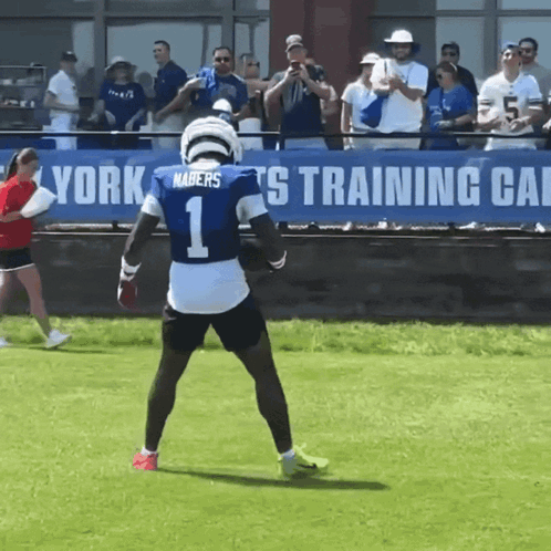 A Football Player Wearing A Number 1 Jersey Stands On The Field GIF