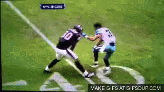 A Football Player Wearing A Number 10 Jersey Is Fighting Another Player GIF