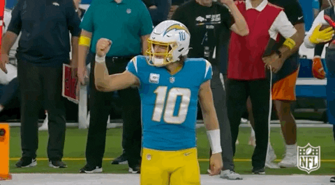 A Football Player Wearing A Number 10 Jersey Is Standing On A Field . GIF