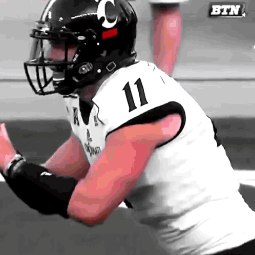 a football player wearing a number 11 jersey