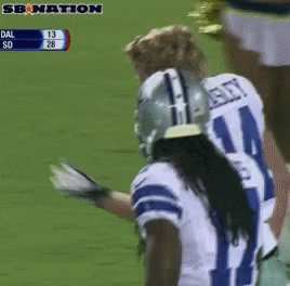 a football player wearing a number 21 jersey stands on the field