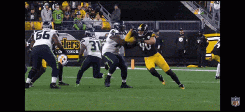 A Football Player Wearing A Number 40 Jersey Is Being Tackled By Another Player GIF