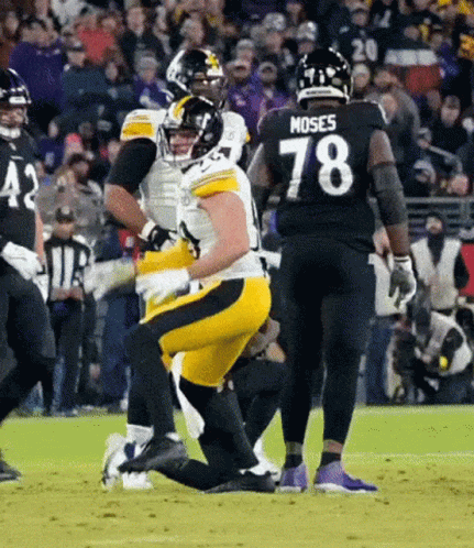 A Football Player Wearing A Number 78 Jersey Is Kneeling On The Field . GIF