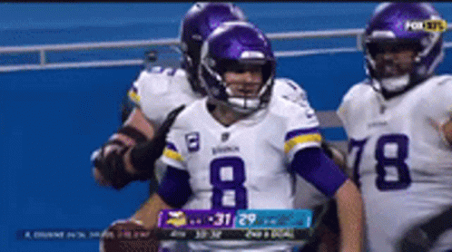 A Football Player Wearing A Number 8 Jersey Holds A Football GIF