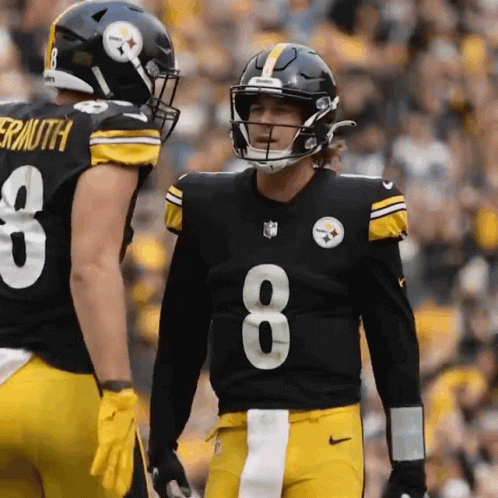 A Football Player Wearing A Number 8 Jersey Talks To Another Player GIF