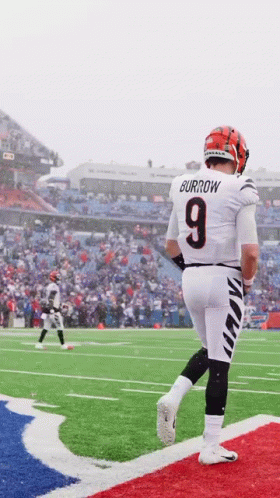 A Football Player Wearing A Number 9 Jersey Is Walking On The Field GIF