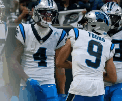A Football Player Wearing A Number 9 Jersey Talks To Another Player GIF
