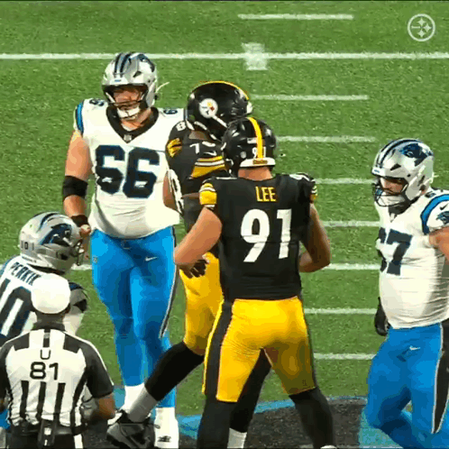 A Football Player Wearing A Number 91 Jersey Talks To Another Player GIF