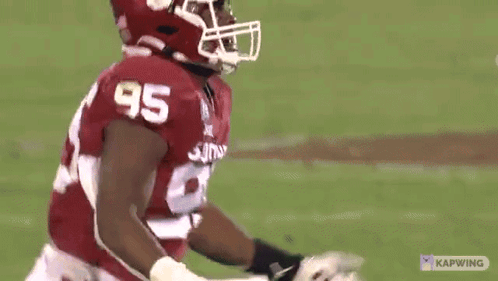 A Football Player Wearing A Number 95 Jersey GIF