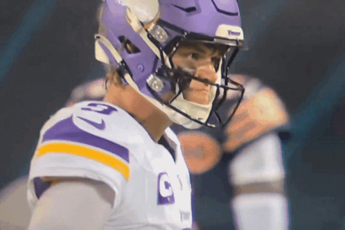 A Football Player Wearing A Purple Helmet And A Jersey With The Number 9 On It GIF