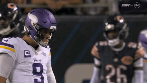 A Football Player Wearing A Purple Helmet With The Number 9 On It GIF