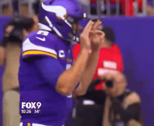 A Football Player Wearing A Purple Jersey With The Number 27 GIF