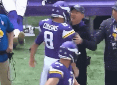 A Football Player Wearing A Purple Jersey With The Number 8 On It GIF