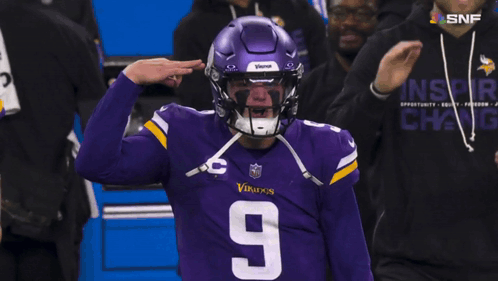 A Football Player Wearing A Purple Vikings Helmet And Jersey GIF