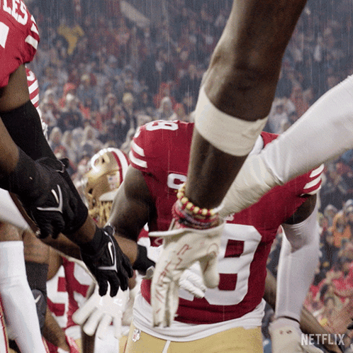 A Football Player Wearing A Red And White Jersey With The Number 8 On It GIF