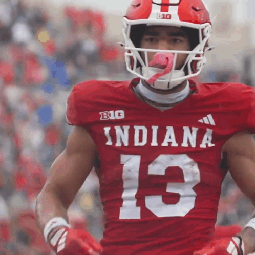 A Football Player Wearing A Red Indiana Jersey With The Number 13 On It GIF