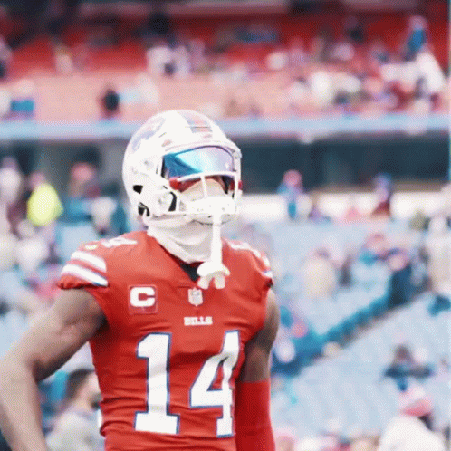 A Football Player Wearing A Red Jersey With The Number 14 On The Front GIF