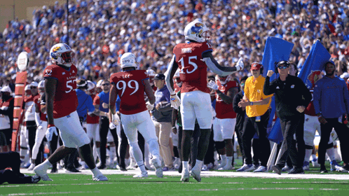 A Football Player Wearing A Red Jersey With The Number 15 On It GIF