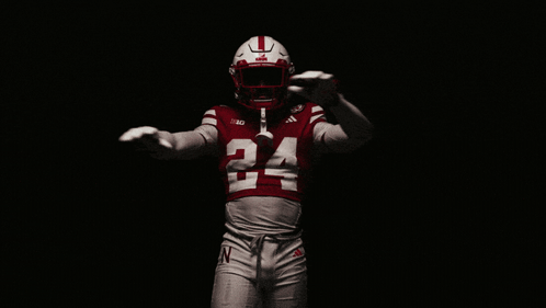 A Football Player Wearing A Red Jersey With The Number 24 GIF