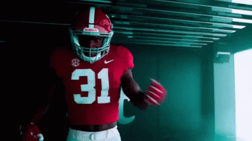 A Football Player Wearing A Red Jersey With The Number 31 GIF