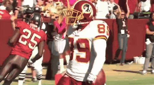 A Football Player Wearing A Red Jersey With The Number 8 On It GIF