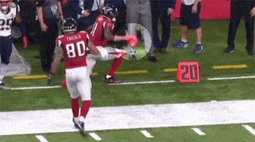 A Football Player Wearing A Red Jersey With The Number 80 On It GIF