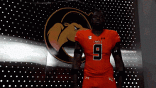 A Football Player Wearing A Red Jersey With The Number 9 GIF