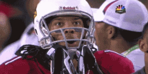 A Football Player Wearing A White Helmet That Says Riddell On It GIF