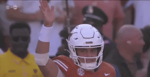 a football player wearing a white helmet with the letter s on it