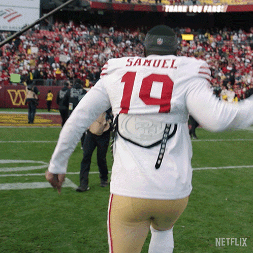 A Football Player Wearing A White Jersey With The Number 19 On The Back GIF