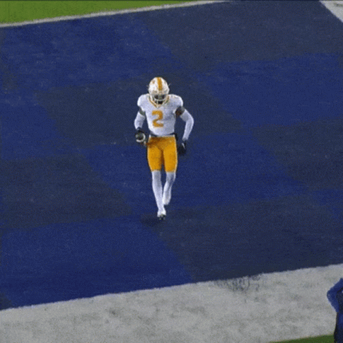 A Football Player Wearing A White Jersey With The Number 2 On It GIF