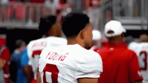 A Football Player Wearing A White Jersey With The Number 7 On It GIF