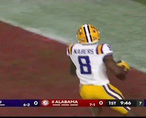 A Football Player Wearing A White Jersey With The Number 8 On It GIF