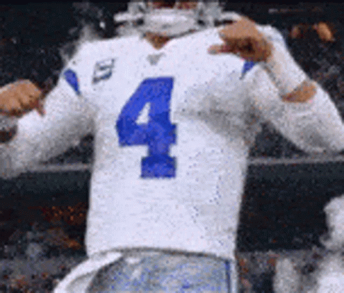 A Football Player Wearing A White Jersey With The Number Four On It Is Giving A Thumbs Up . GIF