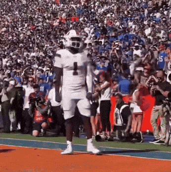 a football player wearing a white uniform with the number 1 on it