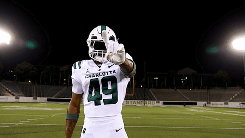 a football player wearing a white uniform with the number 49 on it